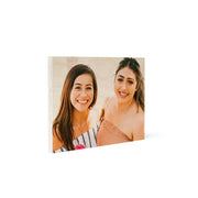 Two girls smiling and posing for a photo on an 8x10 wood print vintage display