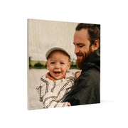 Man holding a baby in arms with Birch Vintage Matte Square Prints backdrop