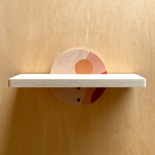 White wall shelf with painted semicircle support, ideal for a sturdy wall decor setup